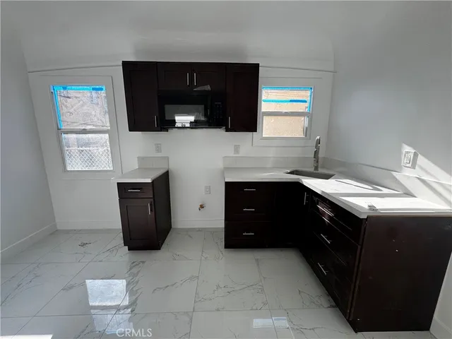 a kitchen with a sink and a stove top oven
