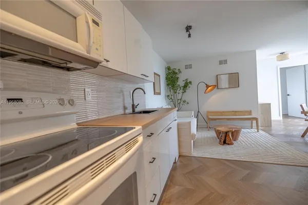 a view of a kitchen with a sink and cabinets