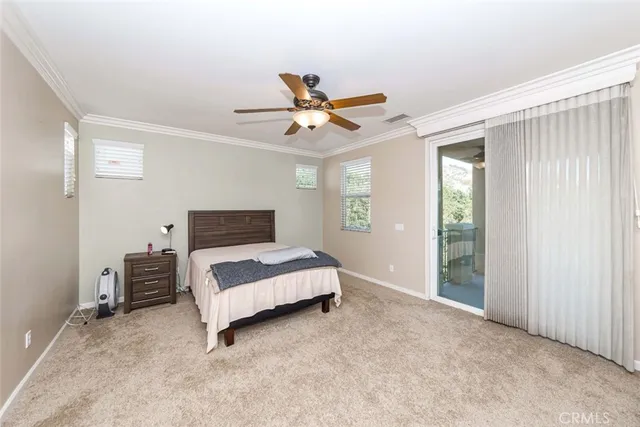 a bedroom with a bed and a ceiling fan in it