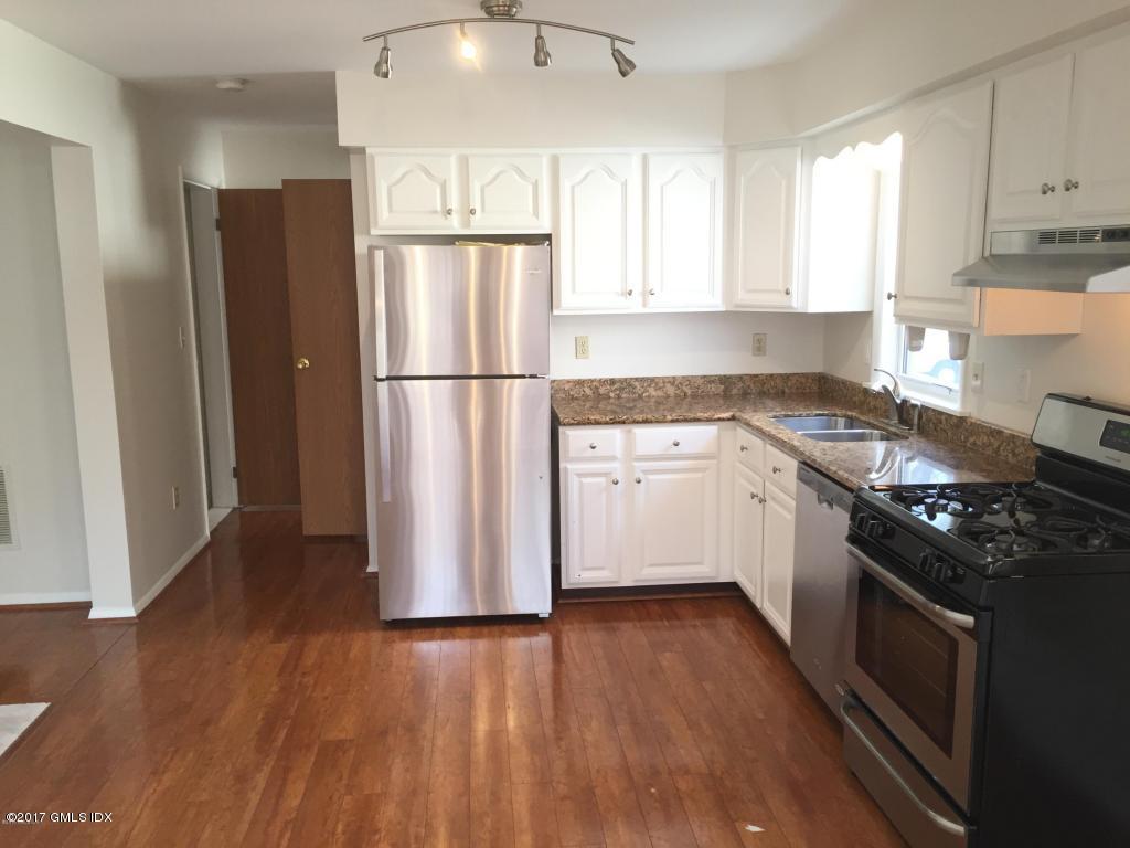 6 Booth Court, Unit B Greenwich, CT 06830 - Photo 2 of 9 a kitchen with a stove a refrigerator and a sink