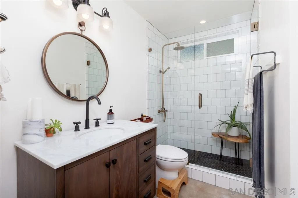 2112 Ramada Drive Oceanside, CA 92056 - Photo 11 of 25 a bathroom with a sink a toilet and shower