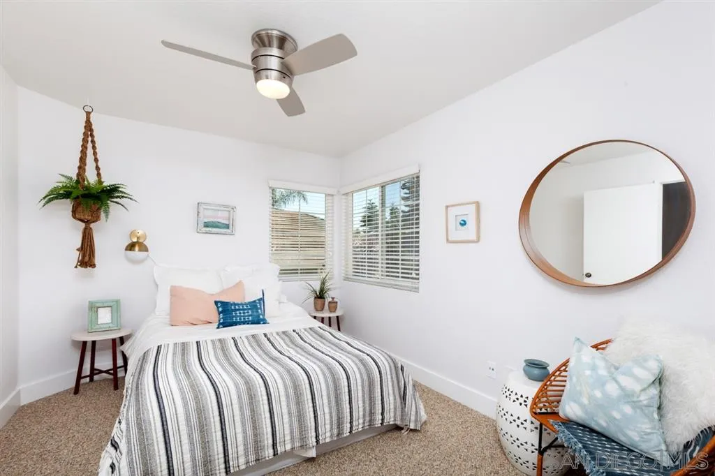 2112 Ramada Drive Oceanside, CA 92056 - Photo 12 of 25 a bedroom with a bed and a chandelier