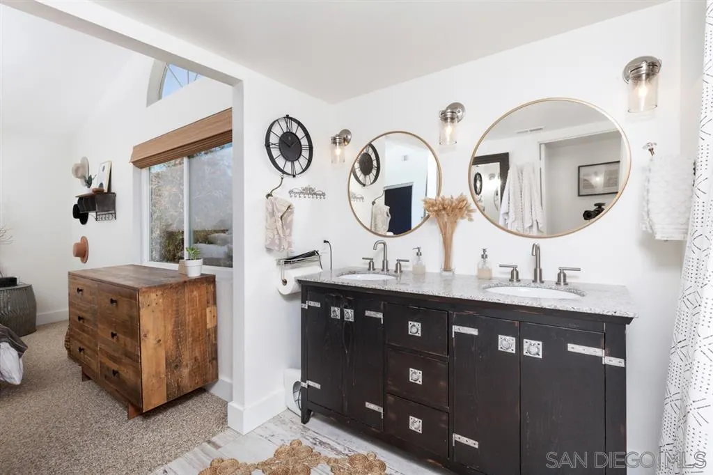 2112 Ramada Drive Oceanside, CA 92056 - Photo 20 of 25 a bathroom with a double vanity sink and a mirror