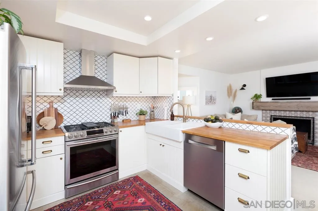 2112 Ramada Drive Oceanside, CA 92056 - Photo 5 of 25 a kitchen with stainless steel appliances a stove a sink and a microwave