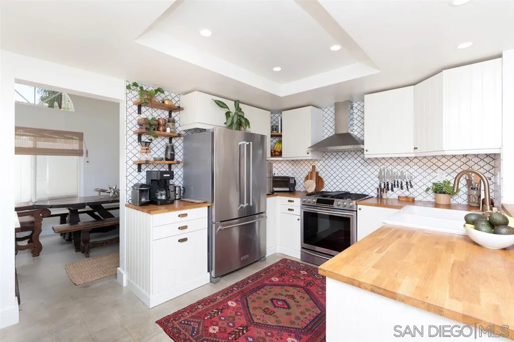 2112 Ramada Drive Oceanside, CA 92056 - Photo 6 of 25 a kitchen with a refrigerator and a stove top oven