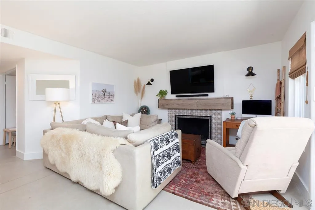 2112 Ramada Drive Oceanside, CA 92056 - Photo 9 of 25 a living room with furniture a flat screen tv and a fireplace