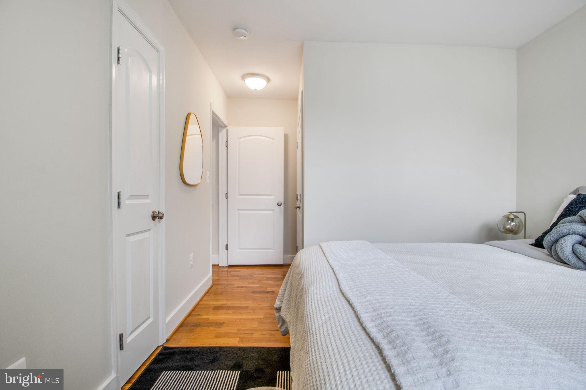 417 18th Street Northeast, Unit 101 Washington, DC 20002 - Photo 12 of 57 a bedroom with a bed and wooden floor