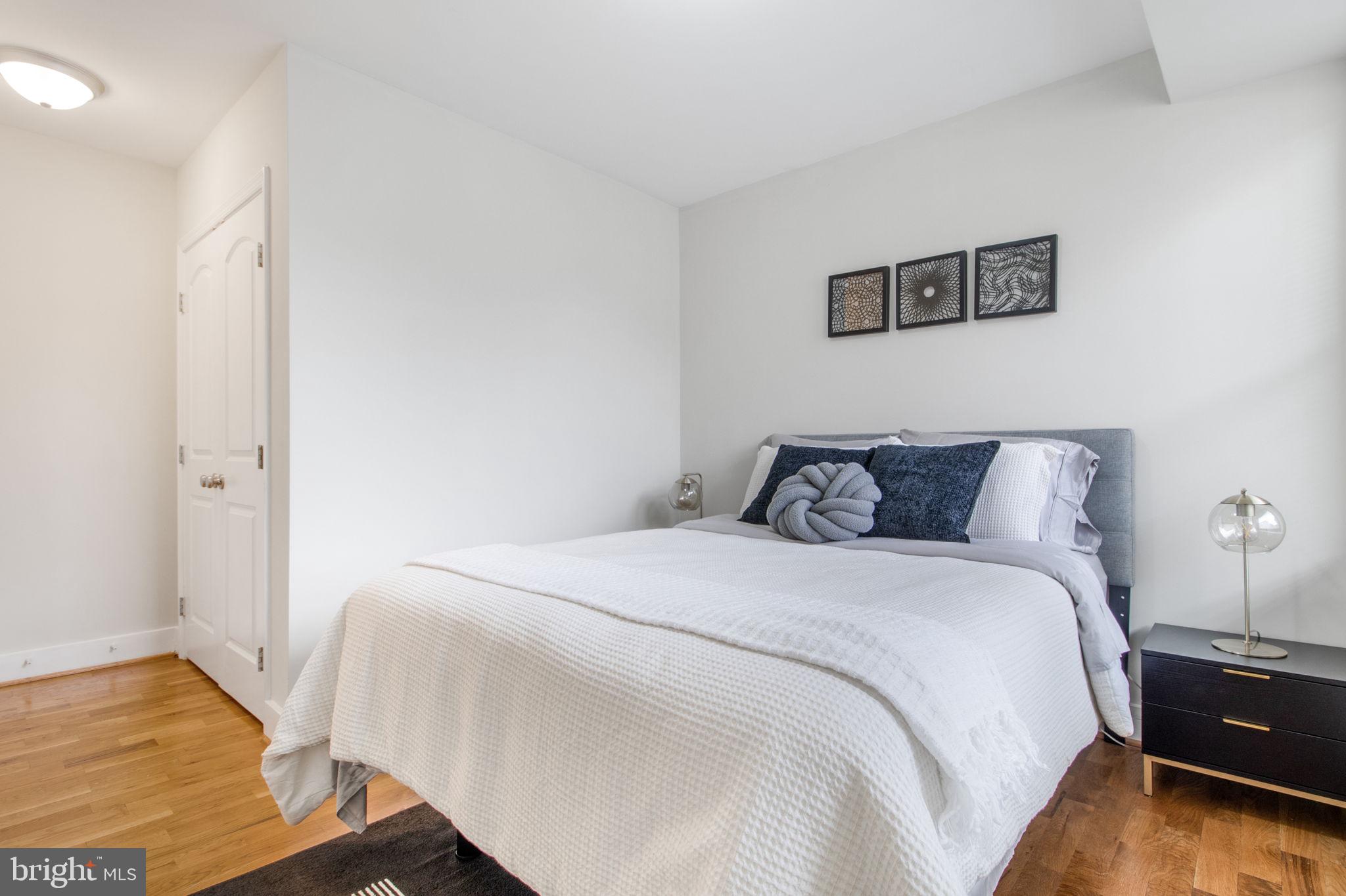 417 18th Street Northeast, Unit 101 Washington, DC 20002 - Photo 13 of 57 a bedroom with a bed and wooden floor