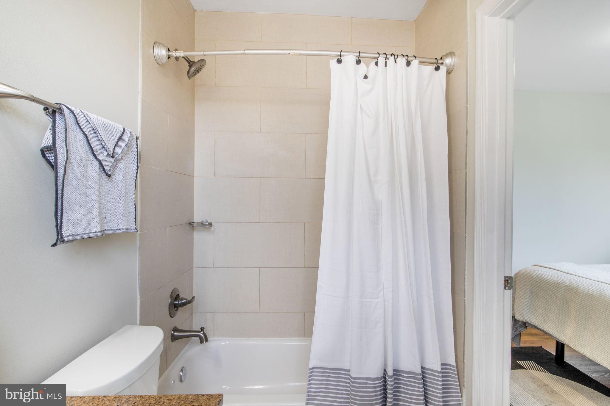 417 18th Street Northeast, Unit 101 Washington, DC 20002 - Photo 16 of 57 a bathroom with a sink and a shower curtain