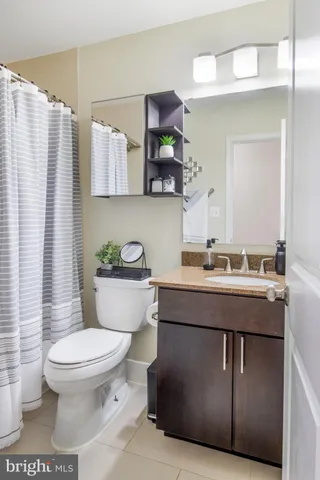 a bathroom with a sink toilet and mirror