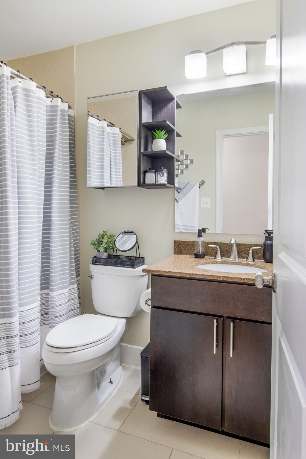 417 18th Street Northeast, Unit 101 Washington, DC 20002 - Photo 19 of 57 a bathroom with a toilet a sink and mirror