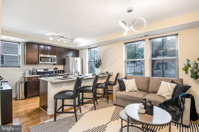 a living room with furniture and a floor to ceiling window