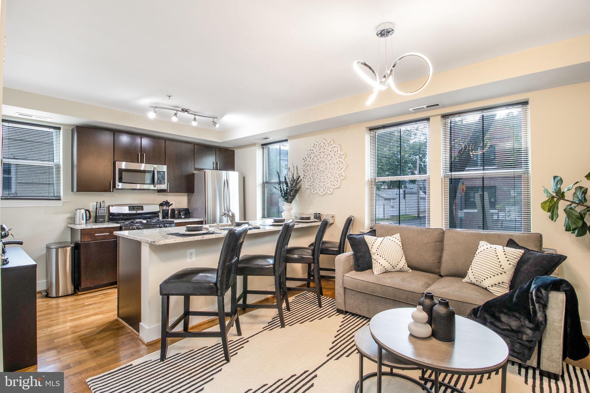 417 18th Street Northeast, Unit 101 Washington, DC 20002 - Photo 25 of 57 a living room with furniture kitchen and a large window