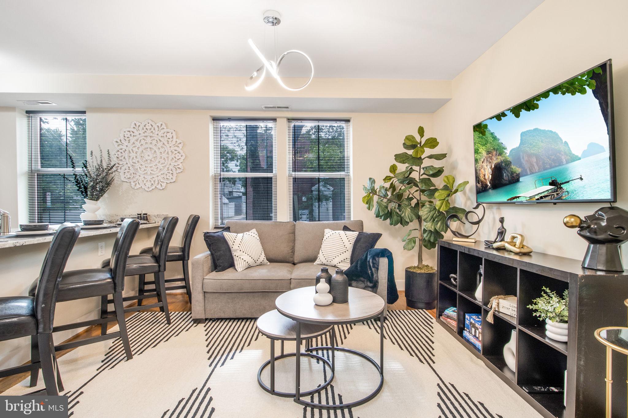 417 18th Street Northeast, Unit 101 Washington, DC 20002 - Photo 26 of 57 a living room with furniture and a floor to ceiling window