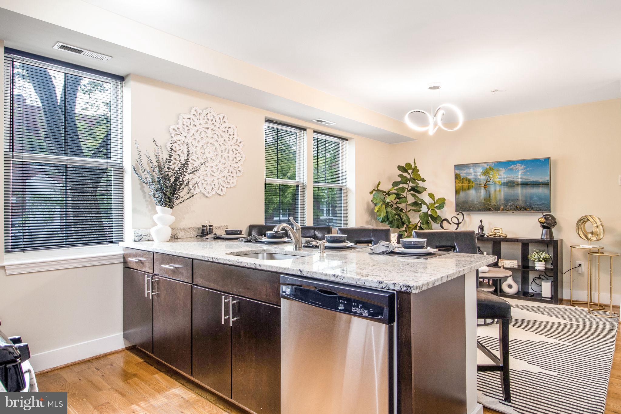 417 18th Street Northeast, Unit 101 Washington, DC 20002 - Photo 29 of 57 a kitchen with a sink stove and cabinets