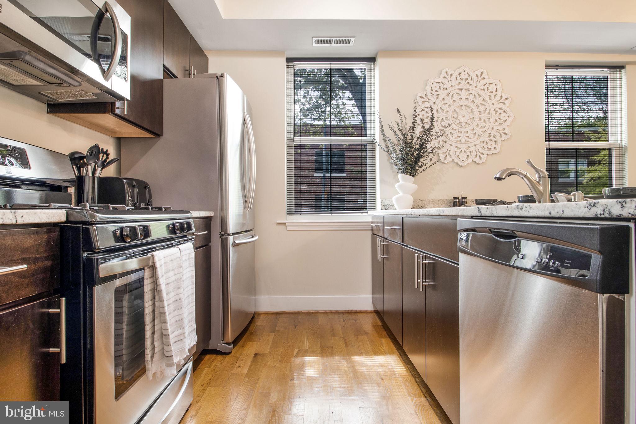 417 18th Street Northeast, Unit 101 Washington, DC 20002 - Photo 30 of 57 a kitchen with a stove and a refrigerator