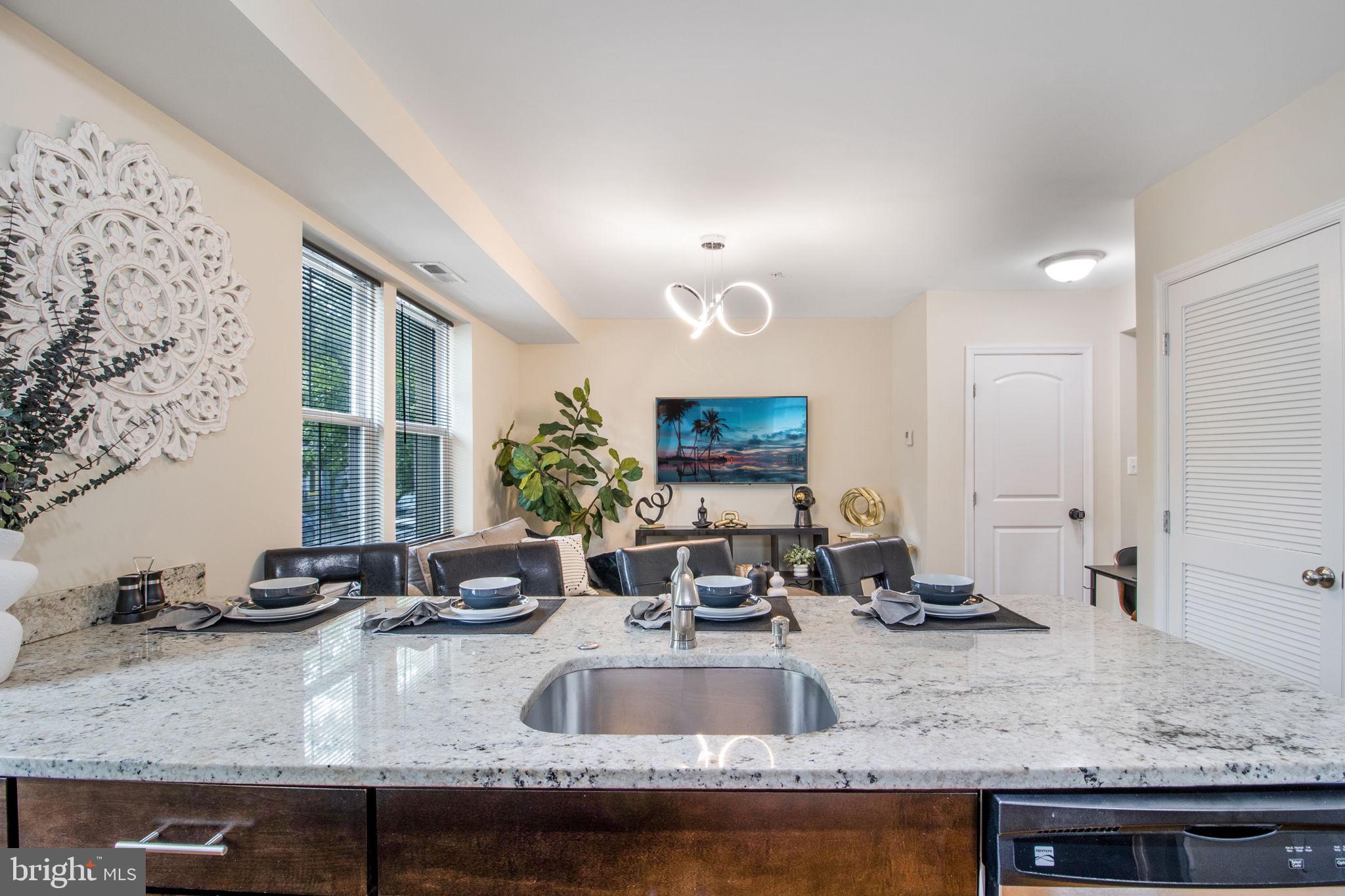 417 18th Street Northeast, Unit 101 Washington, DC 20002 - Photo 32 of 57 a view of a kitchen with granite countertop a sink and a counter top space