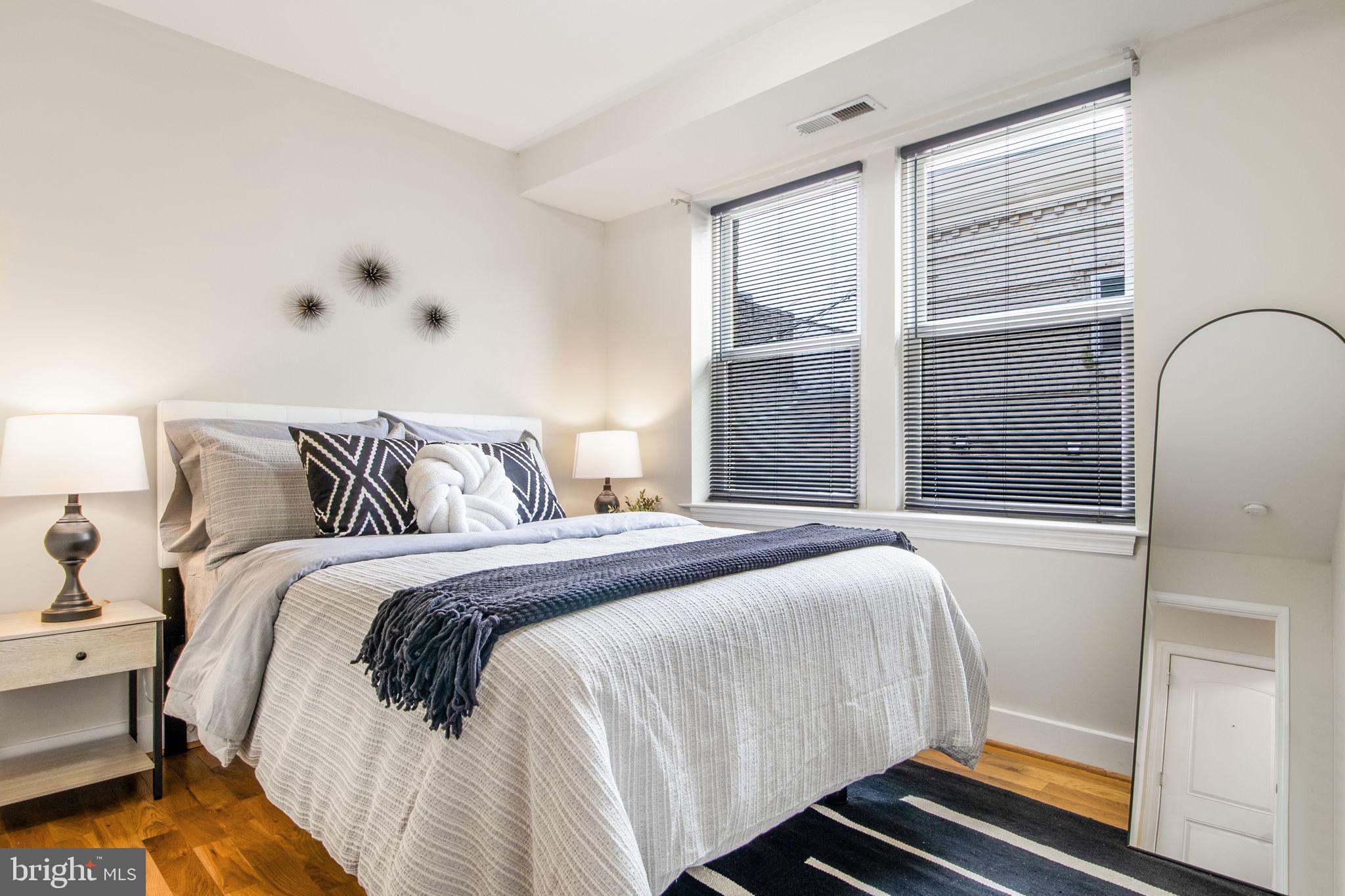 417 18th Street Northeast, Unit 101 Washington, DC 20002 - Photo 4 of 57 a bedroom with a bed and a window