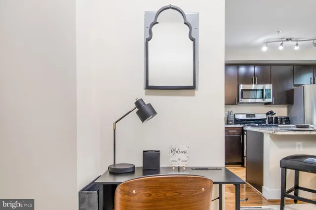 a kitchen with a refrigerator and a stove top oven