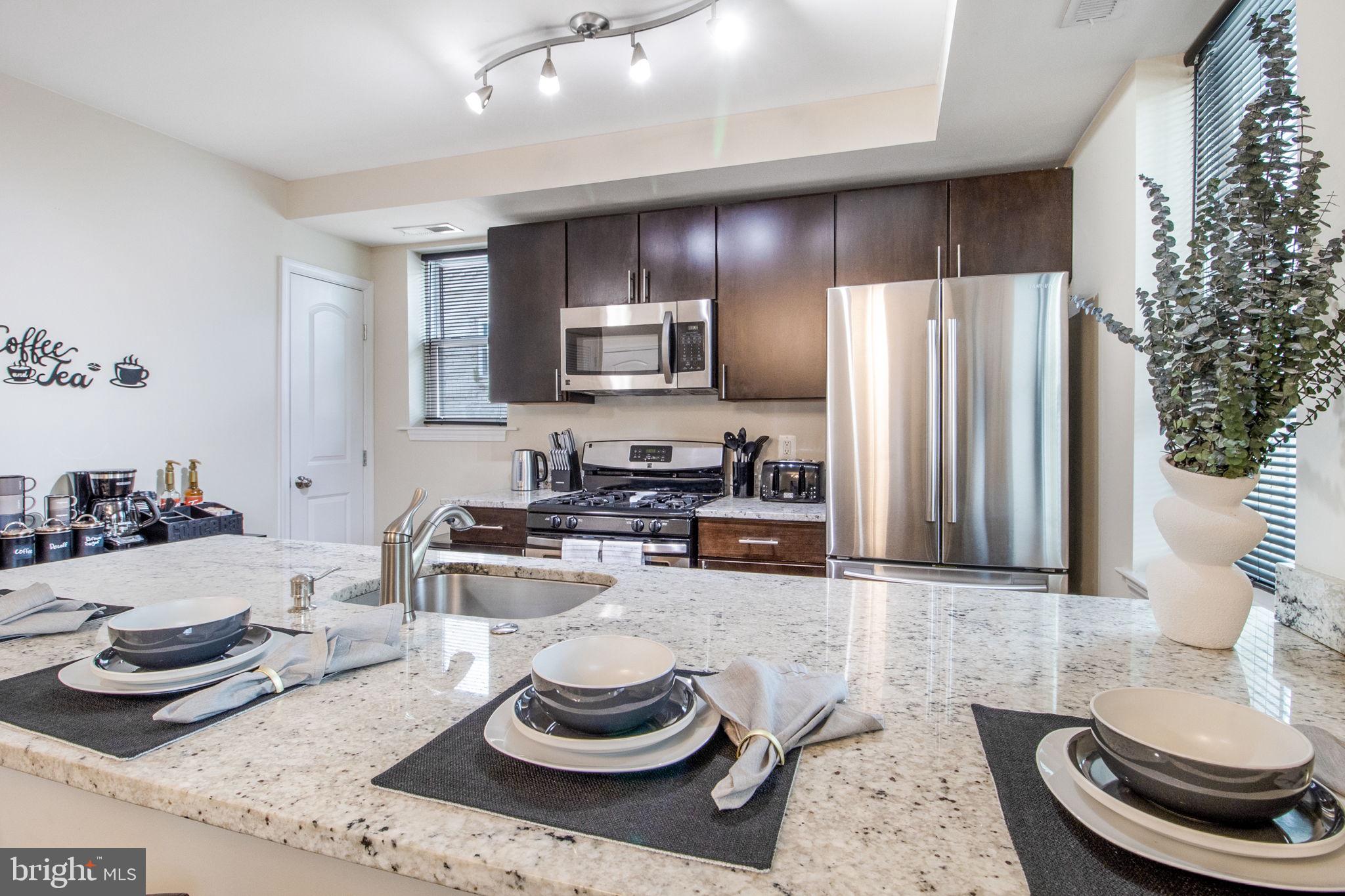 417 18th Street Northeast, Unit 101 Washington, DC 20002 - Photo 46 of 57 a kitchen with a refrigerator and a stove top oven