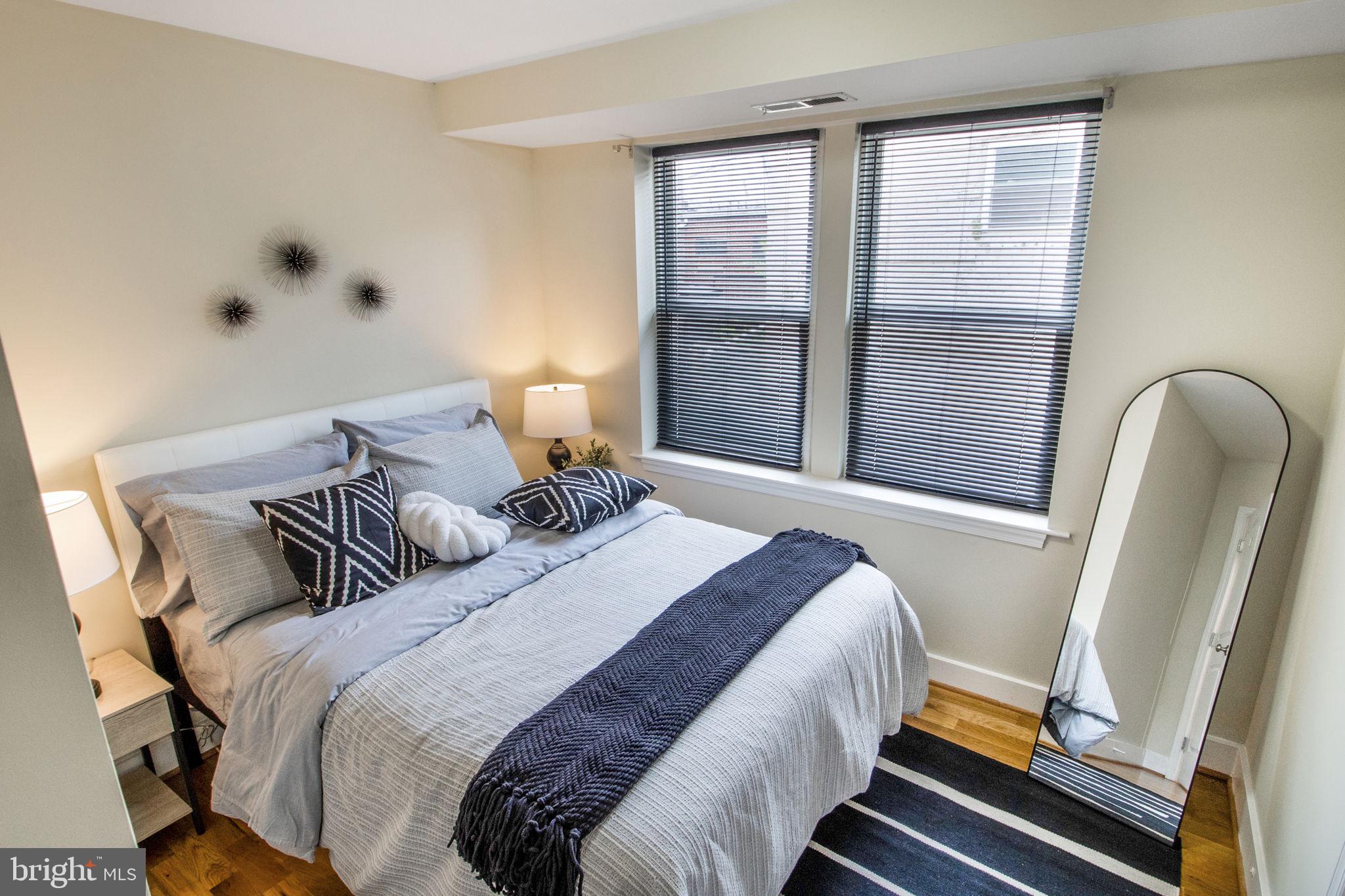 417 18th Street Northeast, Unit 101 Washington, DC 20002 - Photo 51 of 57 a bedroom with a bed and wooden floor