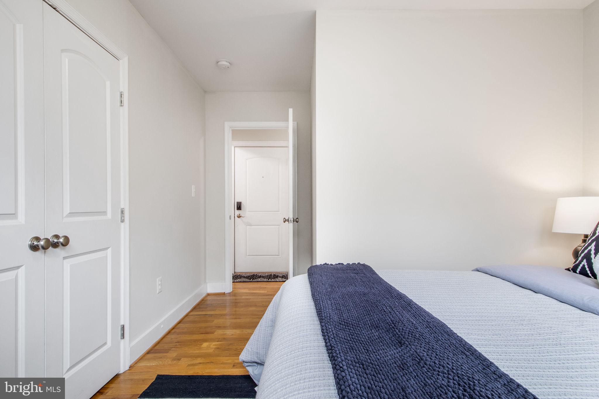 417 18th Street Northeast, Unit 101 Washington, DC 20002 - Photo 7 of 57 a bedroom with a bed and wooden floor