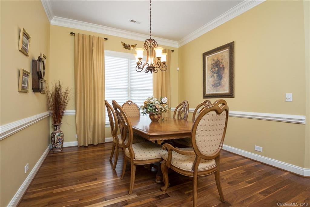 912 Gardenia Street Fort Mill, SC 29708 - Photo 11 of 32 a dining room with furniture a chandelier and wooden floor