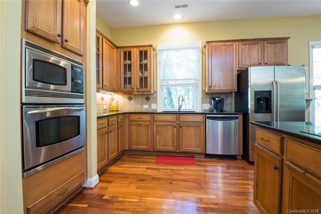 912 Gardenia Street Fort Mill, SC 29708 - Photo 17 of 32 a kitchen with stainless steel appliances granite countertop a stove a sink and a refrigerator