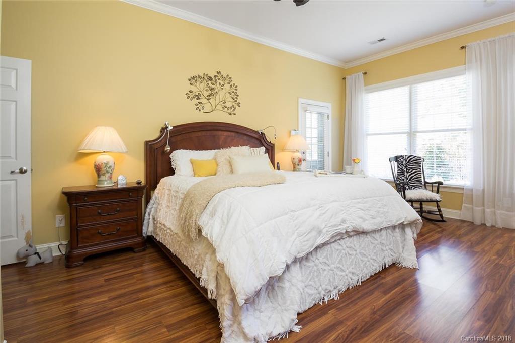 912 Gardenia Street Fort Mill, SC 29708 - Photo 22 of 32 a spacious bedroom with a bed and wooden floor