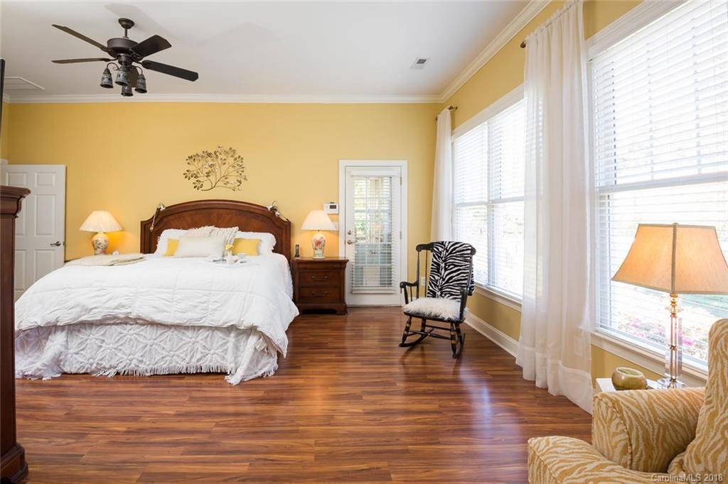 912 Gardenia Street Fort Mill, SC 29708 - Photo 23 of 32 a bedroom with a bed and wooden floor