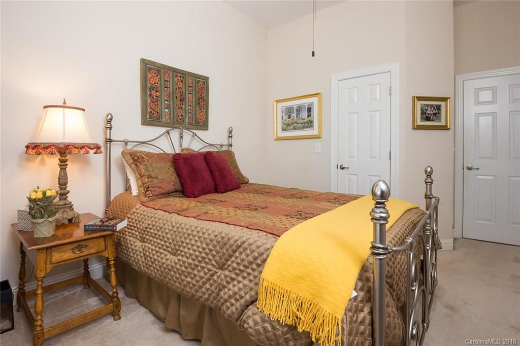 912 Gardenia Street Fort Mill, SC 29708 - Photo 26 of 32 a bedroom with a bed and wooden floor