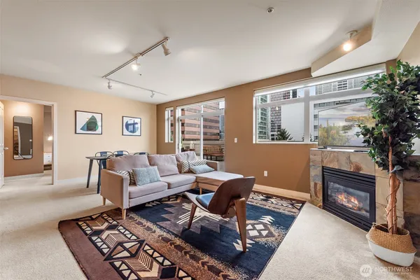 a living room with furniture and a fireplace