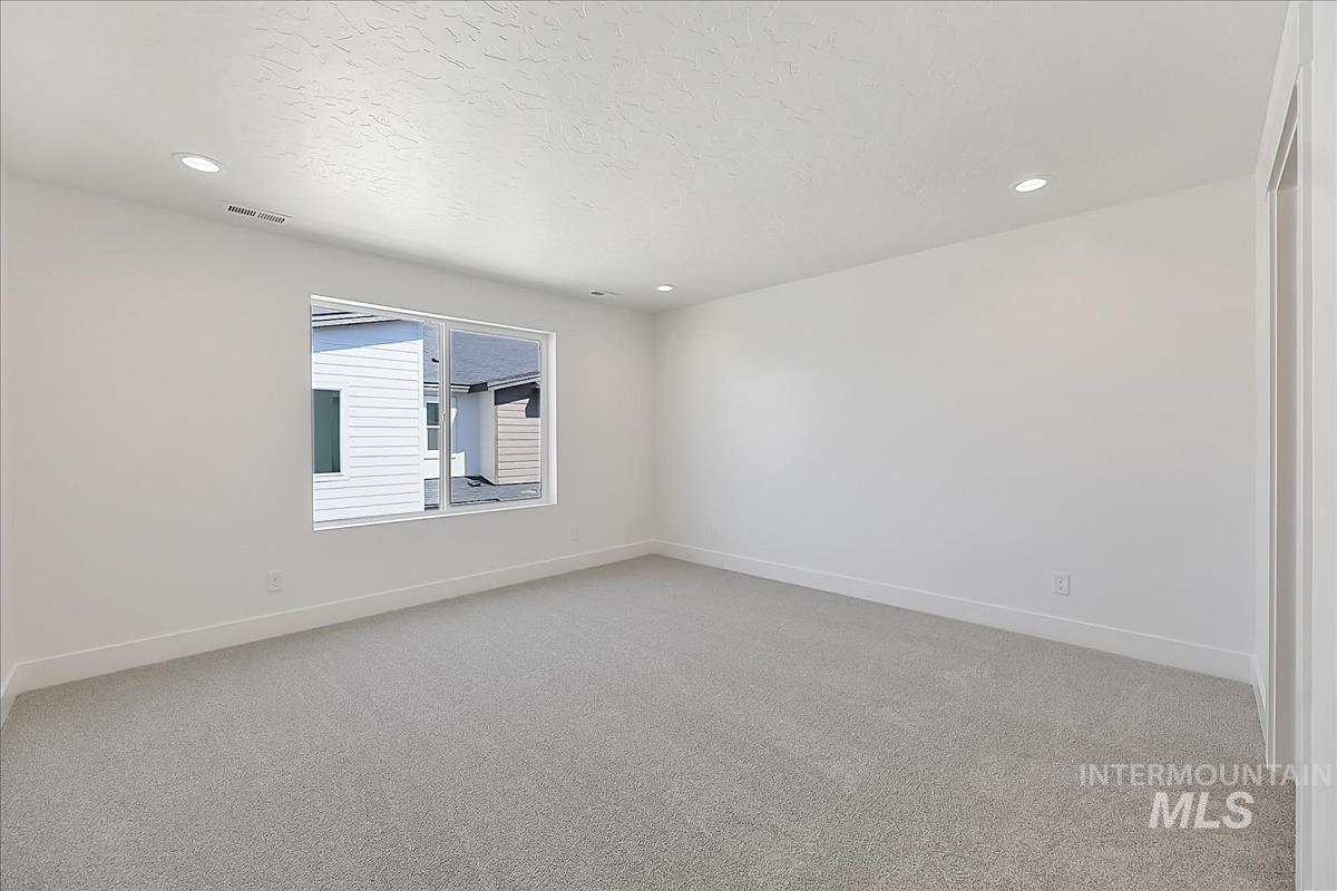 776 South Calhoun Lane Star, ID 83669 - Photo 27 of 49 Bright room featuring a large window, light gray carpeting, white walls, recessed lighting, and white baseboards