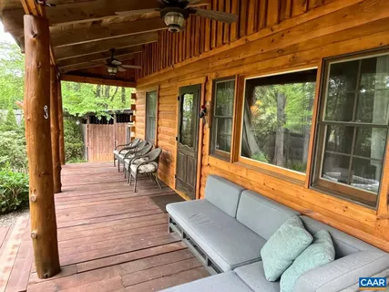 a spacious bedroom with two beds and a ceiling fan