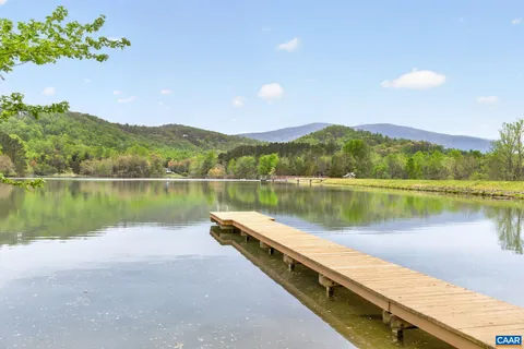 a view of a lake with houses in the background