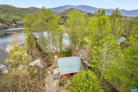 a view of a chair and table in backyard of the house