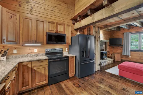 a living room with furniture fireplace and a large window