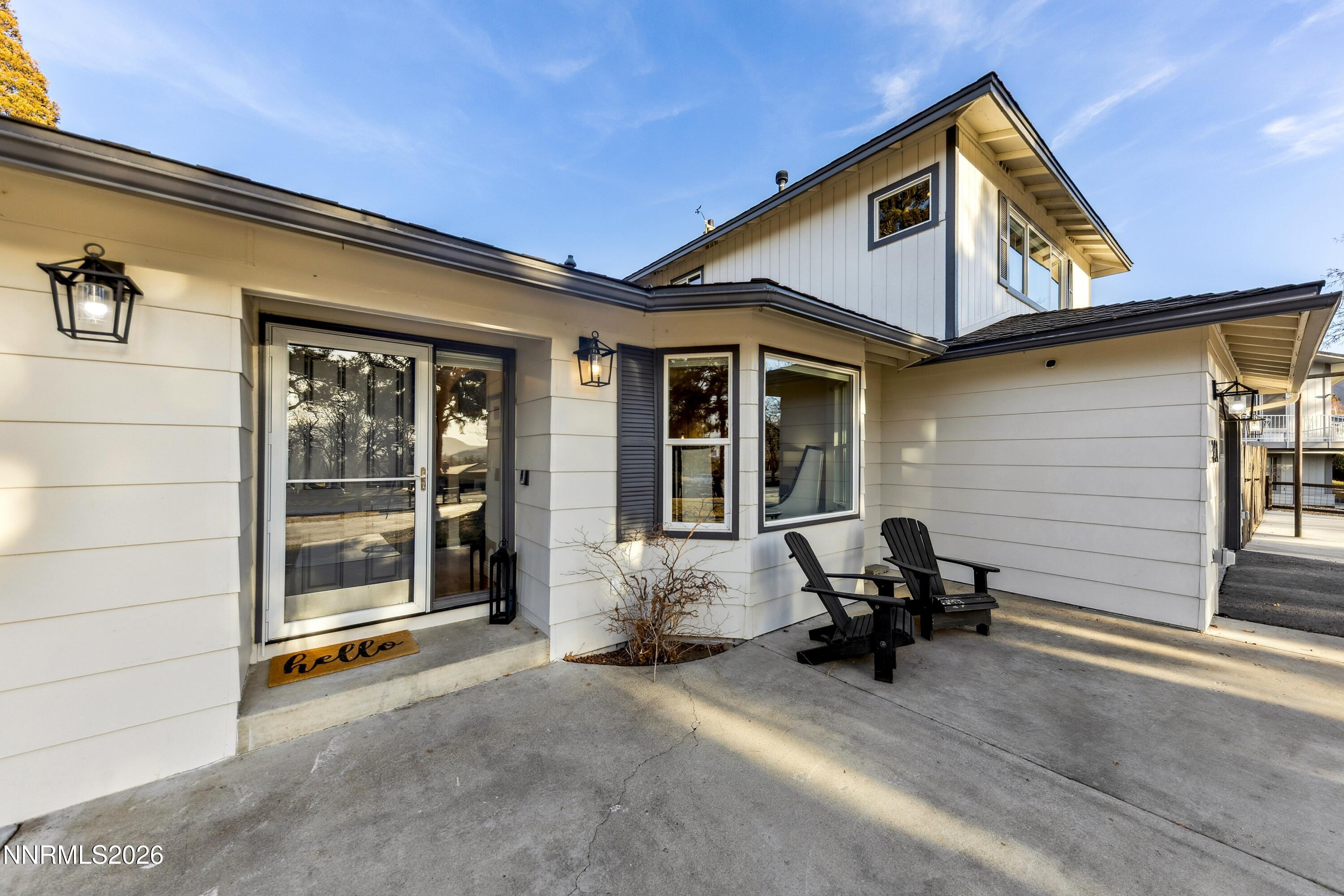 3620 East Hidden Valley Drive Reno, NV 89502 - Photo 17 of 67 a view of a patio with table and chairs and floor to ceiling window