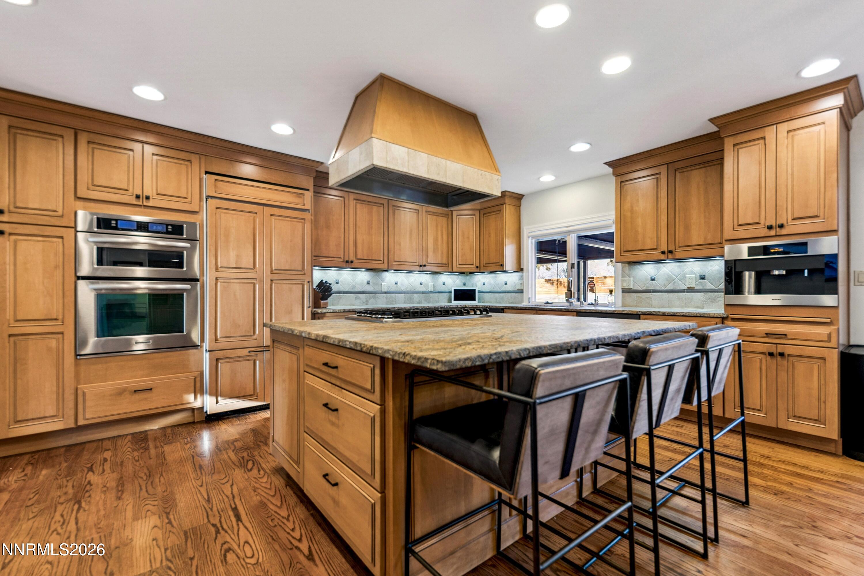 3620 East Hidden Valley Drive Reno, NV 89502 - Photo 22 of 67 a kitchen with stainless steel appliances granite countertop a stove top oven a sink dishwasher and cabinets with wooden floor