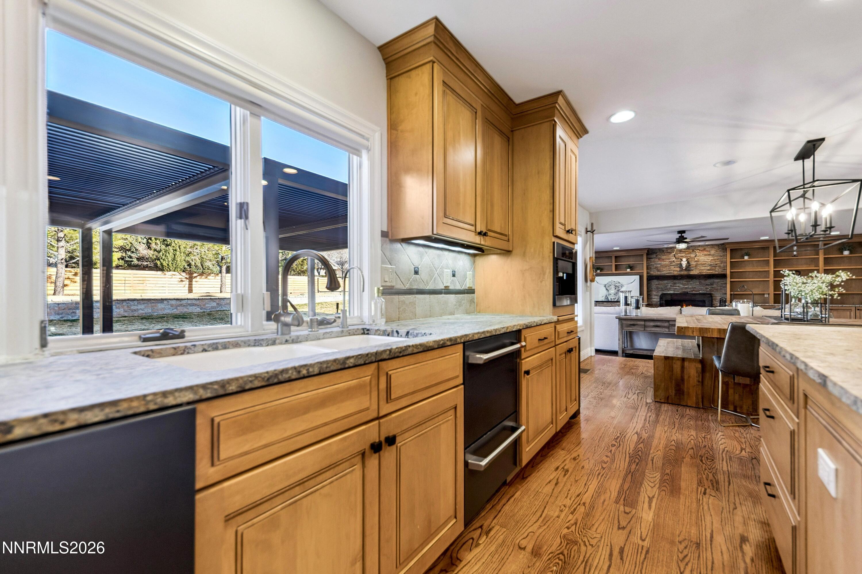3620 East Hidden Valley Drive Reno, NV 89502 - Photo 23 of 67 a kitchen with lots of counter top space and wooden floor