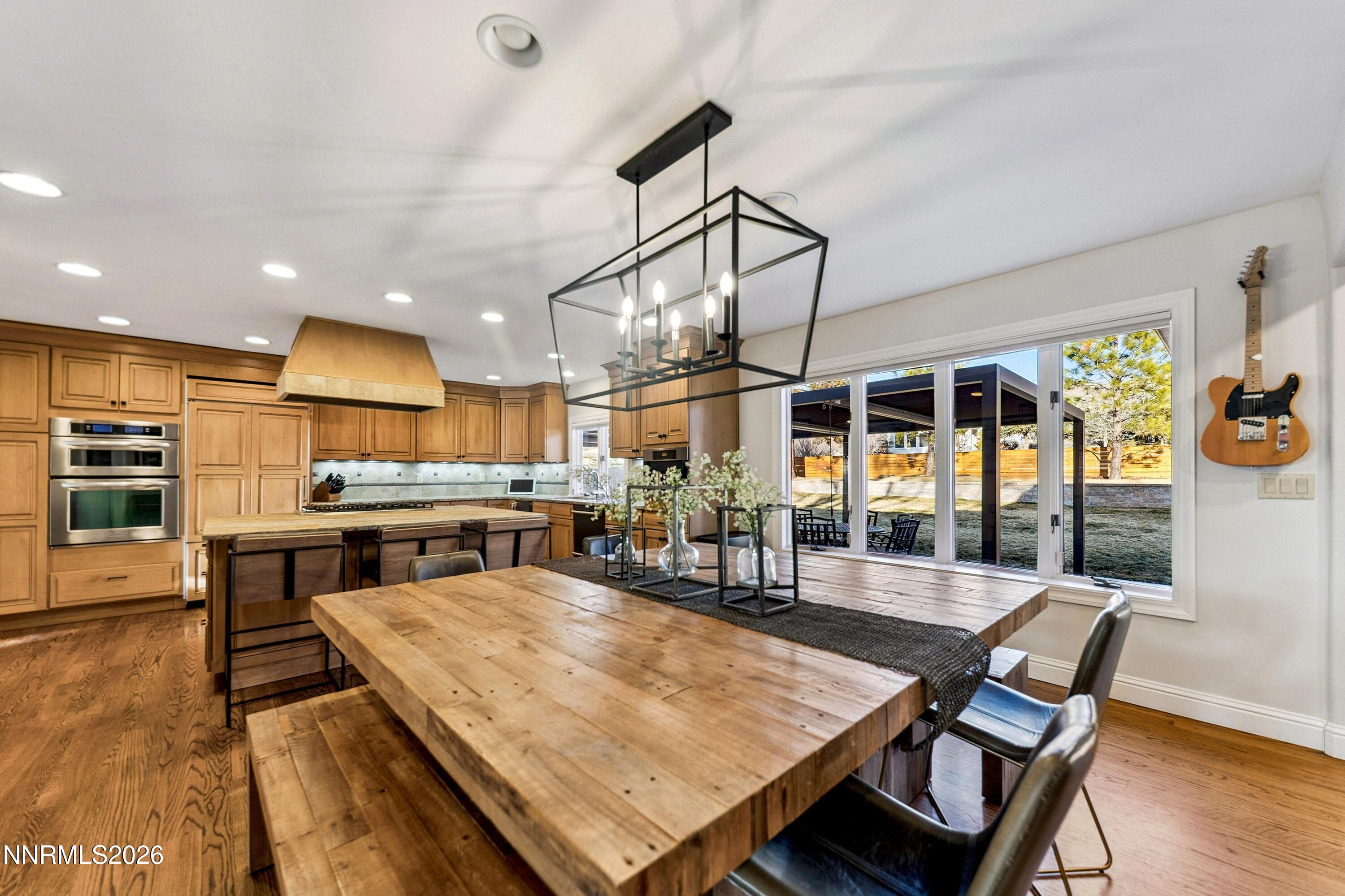 3620 East Hidden Valley Drive Reno, NV 89502 - Photo 25 of 67 a room with stainless steel appliances table chairs and wooden floor