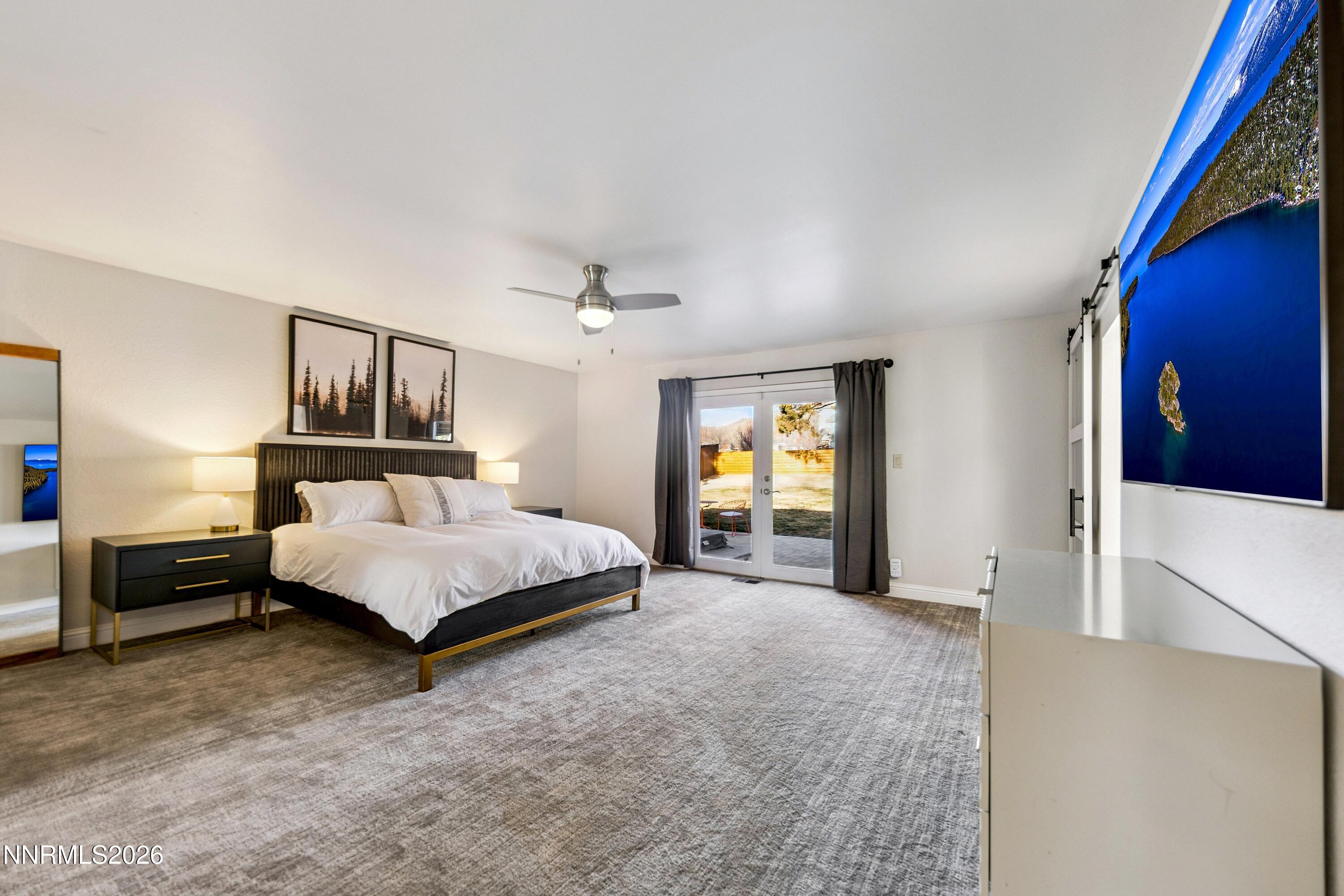 3620 East Hidden Valley Drive Reno, NV 89502 - Photo 30 of 67 a bedroom with a large bed and a chandelier