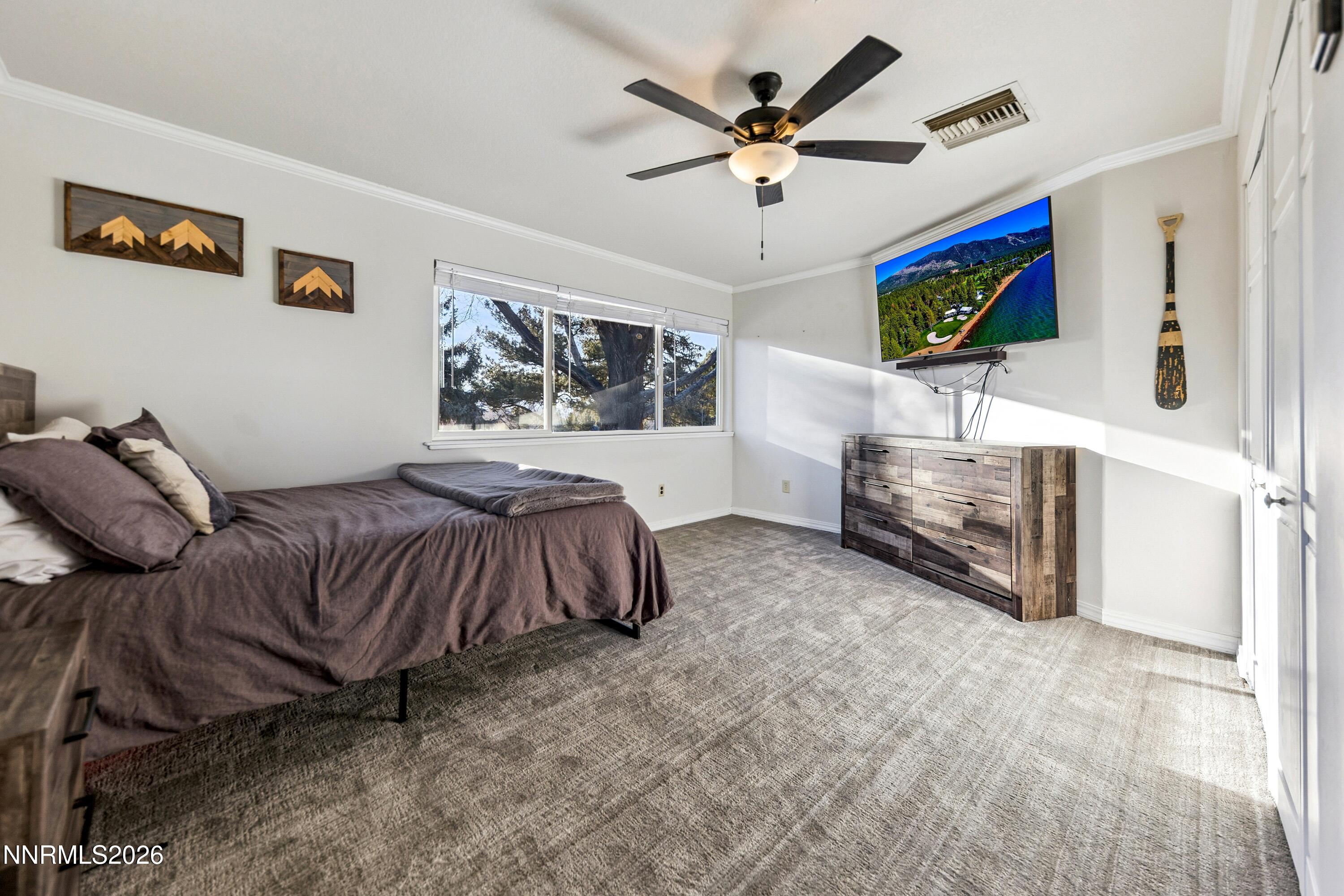 3620 East Hidden Valley Drive Reno, NV 89502 - Photo 38 of 67 a spacious bedroom with a bed and a chandelier