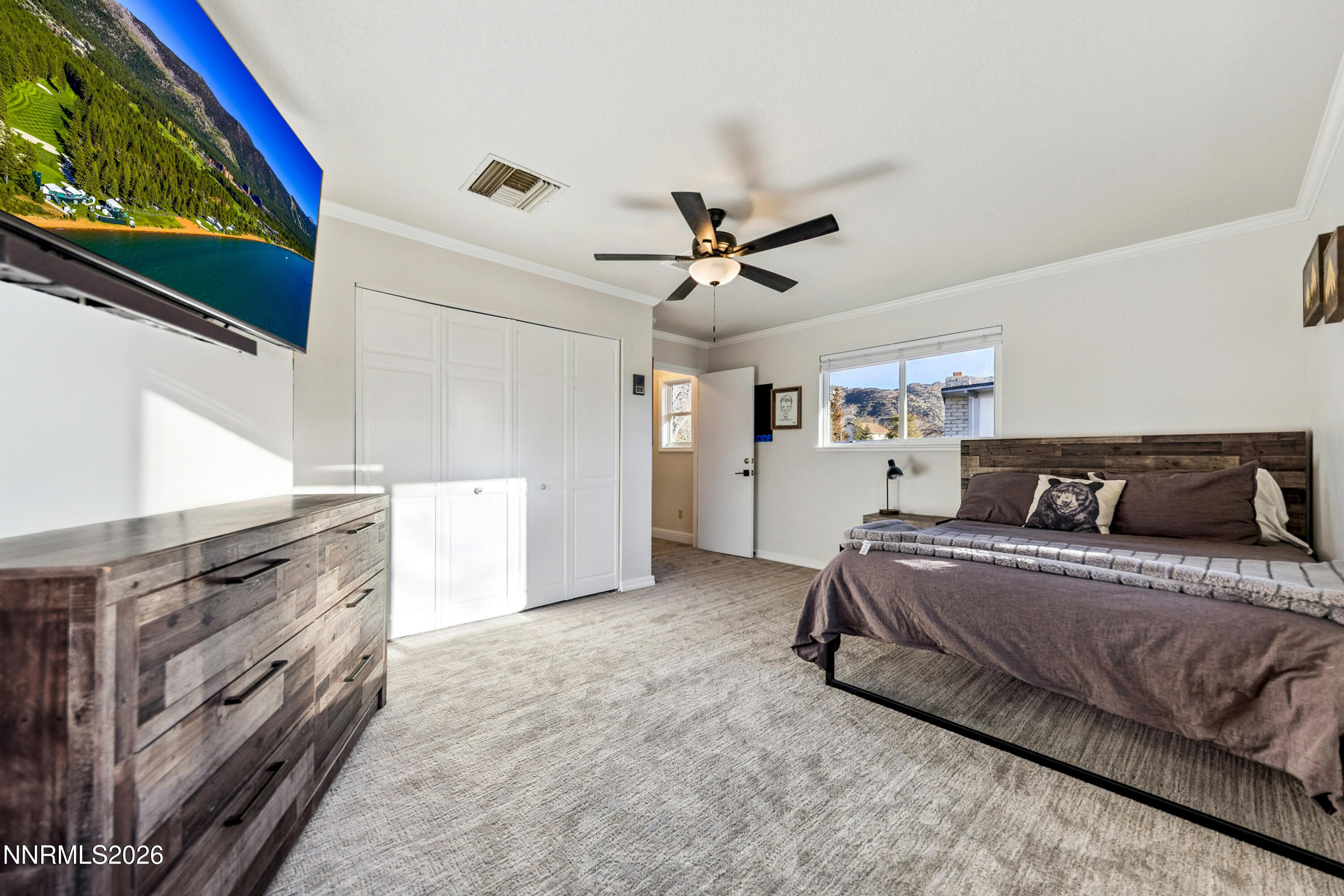 3620 East Hidden Valley Drive Reno, NV 89502 - Photo 39 of 67 a spacious bedroom with a bed and a ceiling fan
