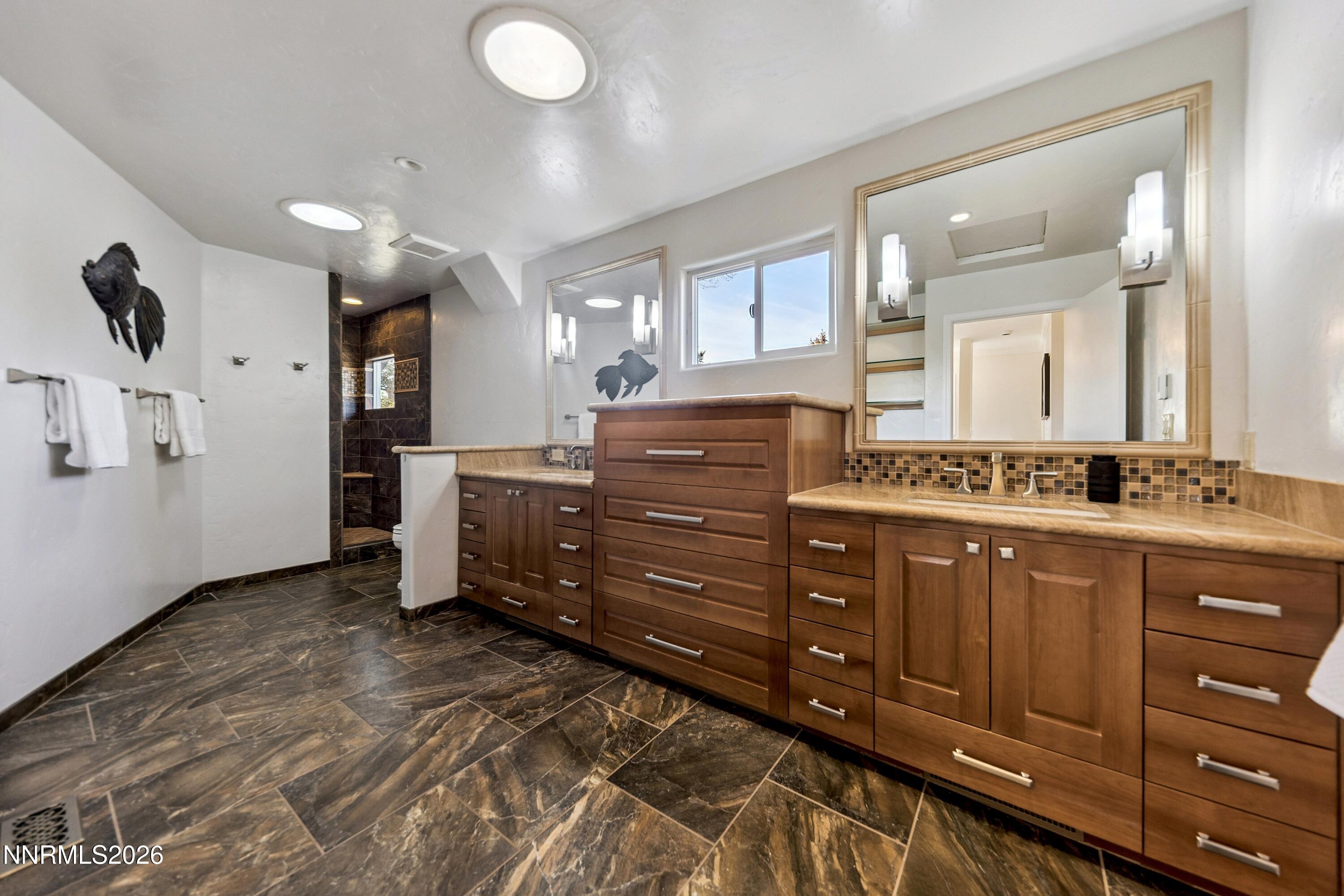 3620 East Hidden Valley Drive Reno, NV 89502 - Photo 42 of 67 a bathroom with a sink vanity and mirror
