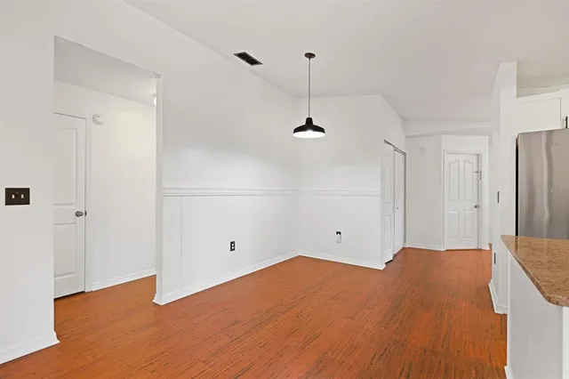 an empty room with fan and windows