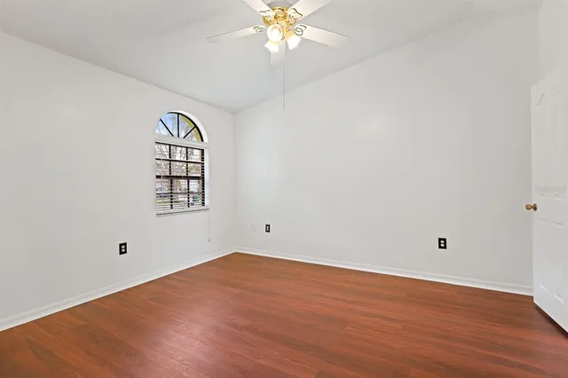 wooden floor in an empty room with a window