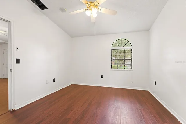 a bathroom with a granite countertop sink and a bathtub
