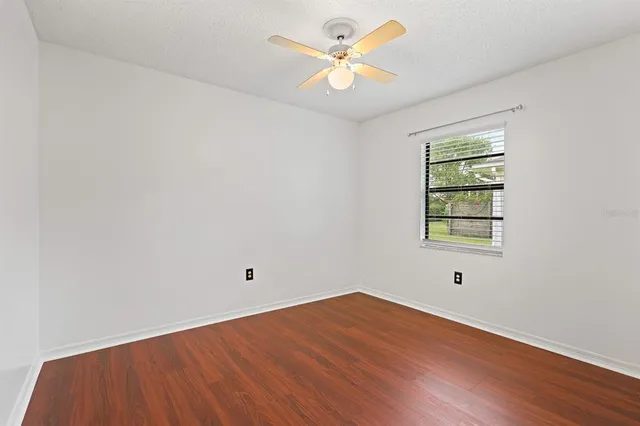 a bathroom with a granite countertop sink a toilet and bathtub