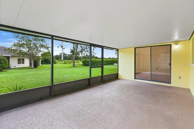 a view of a field of grass and trees